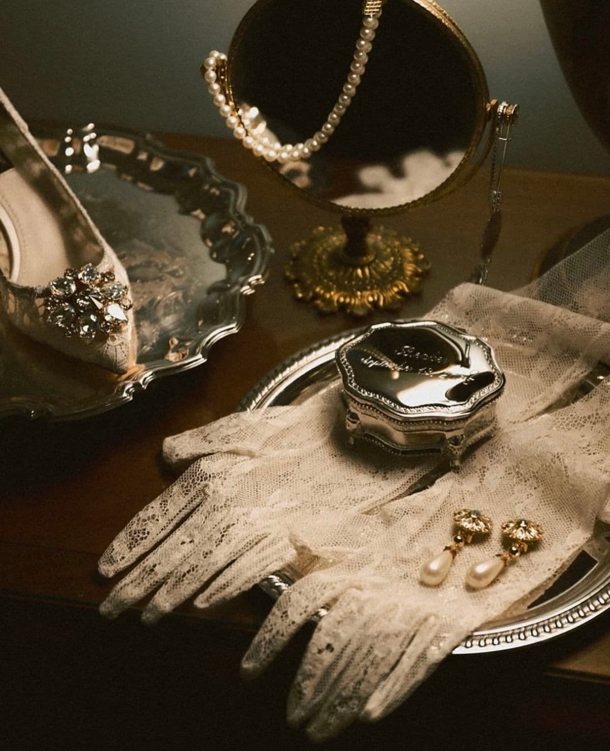 Jewelry arranged beside gloves
