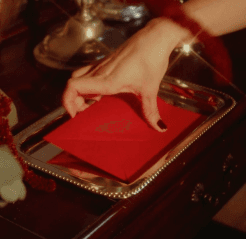 Hand placing a red jewelry box